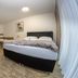 Apparthotel Alte Innbrücke in Neuhaus am Inn: triple hotel room with double bed and twin beds