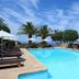 Résidence & Hôtel Aria Marina, Propriano: outdoor pool with loungers, palm trees and sea views