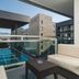 Avala Resort & Villas in Budva balcony view of pool, stone hotel buildings and distant mountains