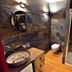 Karczma Rzym in Bydgoszcz bathroom with glass shower, colorful vessel sink, and wall-mounted toilet