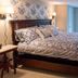 Hudson Manor Bed & Breakfast in Watkins Glen bedroom with king bed, floral bedding, and French doors