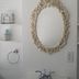 Lost Bayou Guesthouse bathroom vanity with ornate mirror and built-in shelves in Galveston