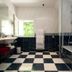 Hostellerie Les Hauts De Sainte Maure bathroom with black-and-white checkerboard floor and tub, Sainte-Maure-de-Touraine