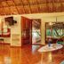 Riviera Maya Suites in Playa del Carmen with tropical suite, open doors to balcony and sitting area