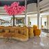 Ozkaymak Marina Hotel in Kemer lobby with curved wicker seating and a pink blossom tree centerpiece