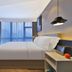 Orange Hotel Beijing Chaoyangmen Yabao Road Children's Hospital room with bed, desk and large window view in Beijing