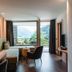 Hotel Bad Fallenbach suite with balcony view of mountains and valley in San Leonardo in Passiria
