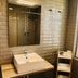 Hotel Finca Alcamino bathroom with vessel sink, large mirror, and window in Mompía