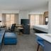 Residence Inn by Marriott Greenville-Spartanburg Airport suite with sofa, desk, bed, and TV in Greenville