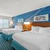 Comfort Inn & Suites Berea guest room with two beds, desk, TV and blue patterned carpet
