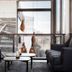 Go Hotel Østerport lounge with dark chairs, low tables and large window view of rail tracks in Copenhagen
