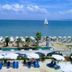 Santa Beach Hotel in Agía Triáda with beach, sea view, sun loungers, umbrellas and sailboat