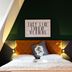Hotel Villa Carlton - Adults Only bedroom in Salzburg with green accent wall and orange headboard