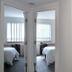 Residence & Conference Centre - Oakville bedroom with mirrored closet and two beds
