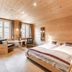 Gasthof Bären in Habkern: cozy wood-paneled double room with twin beds and seating by windows