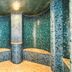 Leonardo Hotel & Residenz München spa shower room with mosaic tile walls in Munich