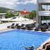 Hotel Tahiti Nui in Papeete with a rooftop pool, lounge chairs, and guests relaxing by the water.