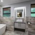 The Cavern in Bonjaneni bathroom with freestanding tub, vanity sink, and mirrored wall