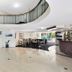 The Wellington Apartment Hotel Brisbane lobby with curved mezzanine, dining area and bar