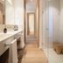 Es Figueral Nou Hotel Rural & Spa in Montuïri: bright spa bathroom with double sinks and glass shower