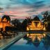 Yoko River Kwai Resort in Ban Lum Sum with a lit infinity pool reflecting a glowing owl sculpture at dusk