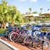 Best Western Plus Yacht Harbor Inn in Dunedin with bicycle surrey carts by the pool and palms