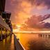 Best Western Plus Yacht Harbor Inn in Dunedin at sunset with waterfront balconies and pier