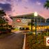 Best Western Plus Yacht Harbor Inn in Dunedin exterior with palm trees and lit entrance at dusk
