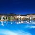 I Giardini di Cala Ginepro Hotel Resort in Cala Liberotto, lit outdoor pool at dusk