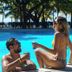 Henry Morgan Hotel & Beach Resort in Coxen Hole poolside couple with ocean and palm trees