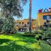 Hacienda de las Flores in San Miguel de Allende, yellow courtyard building with lush garden and pool