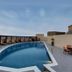 Raf Hotel Apartment in Dubai rooftop pool with lounge chairs and outdoor dining area