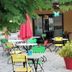 Campanile Maubeuge in Maubeuge outdoor café terrace with colorful tables, chairs and red umbrellas