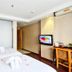 Dunhe Apartment Guangzhou twin room with white beds, wall-mounted TV, and desk