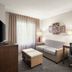 Staybridge Suites Indianapolis-Airport by IHG guest suite with sofa, desk, and window seating in Plainfield