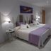 Hotel Valle de Cabezón in Cabezón de la Sal: twin beds with purple accents in a bright guest room