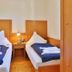 Das Lamm Heidelberg twin guest room with two single beds, bedside lamp, and wood furnishings
