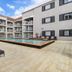 Hope Harbour Hotel in Hope Island with a courtyard pool and lounge chairs beside guest balconies