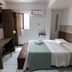 Hotel Gogó da Ema room in Maceió with double bed, desk, TV, and window air conditioner