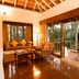 Gateway Chikmagalur in Chikamagalur: airy lounge with forest-view balcony and sliding glass doors