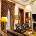 Sultan Inn Boutique Hotel, Baku: elegant guest room with armchair, fireplace, wall mirror and TV