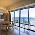 Moon Ocean Ginowan Hotel & Residence room with kitchen, dining table and ocean-view balcony in Ginowan