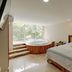 Hotel San Pedro del Fuerte in Medellín room with a round soaking tub by large windows