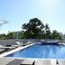 Hotel Tahiti Nui in Papeete rooftop pool with lounge chairs and tropical trees