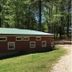 The Bed and Breakfast at Peace Hill Farm in Charles City, rustic cabin-style building beside wooded grounds