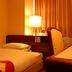 Hiroshima Ekimae Green Hotel guest room with single bed, desk, lamp and chair in Hiroshima
