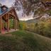 Engadine Inn and Cabins in Candler: open-air pavilion with mountain and autumn forest views