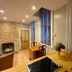 The Old Railway Station, Petworth: cozy guest room with kitchenette, brick fireplace, and large windows