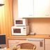 Bordine Guesthouse in Leeuwarden kitchenette with microwave, sink, cabinets and dining chairs