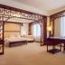 Grand Metropark Hotel Hangzhou guest room with ornate wooden partitions and sitting area